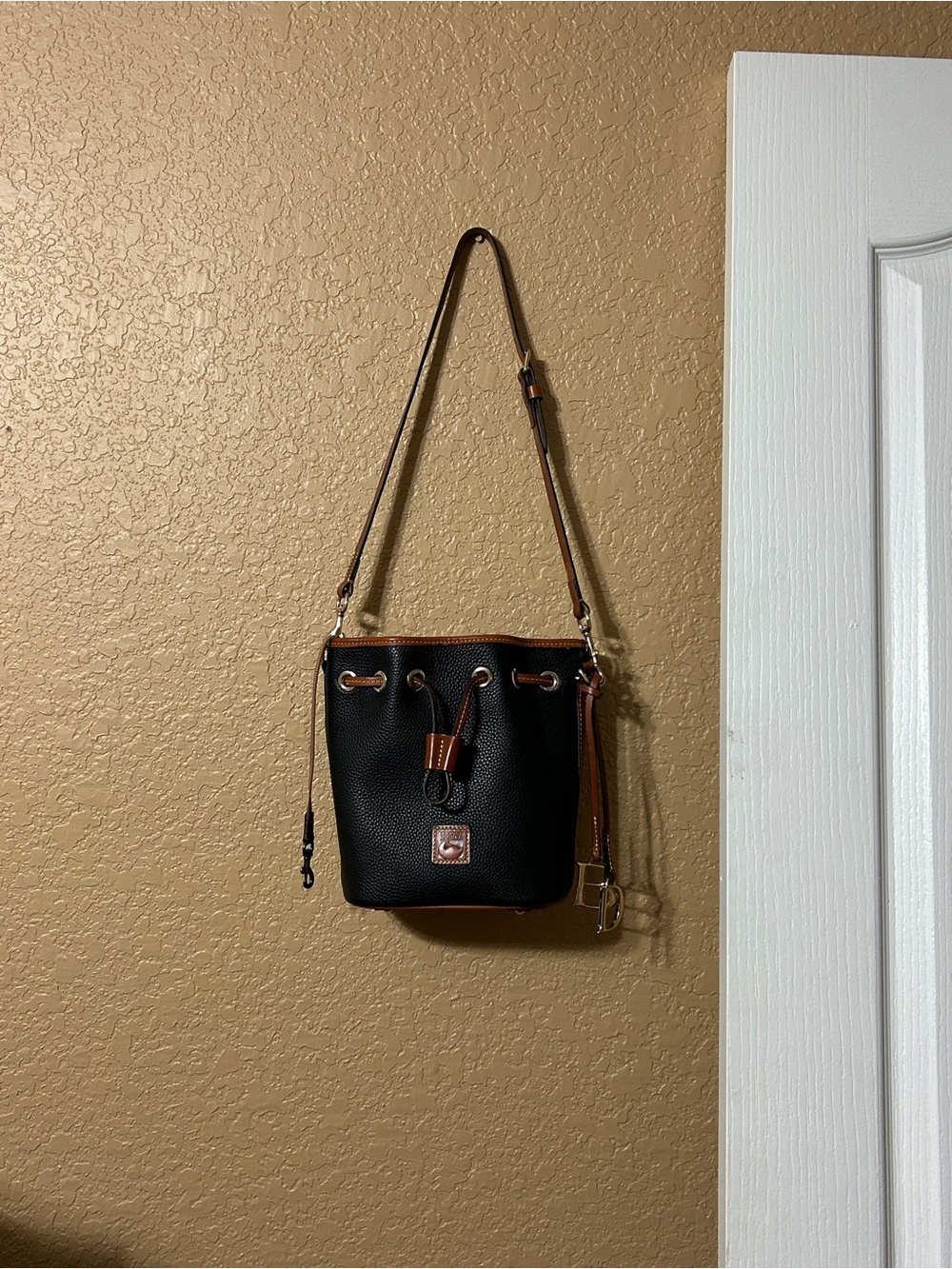 Dooney & Bourke Black Pebbled Leather Drawstring Shoulder Bag with Brown Trim